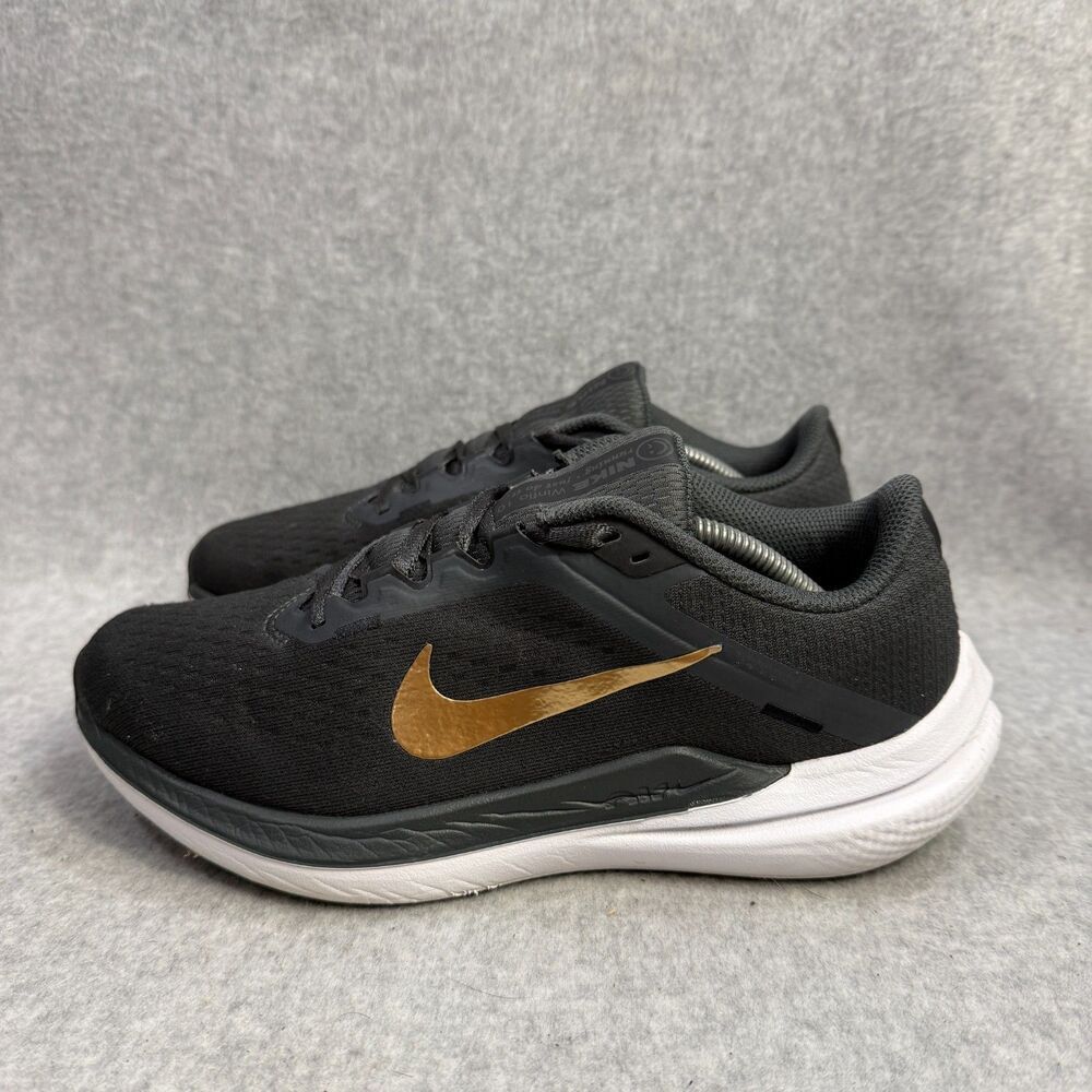 Nike women’s grayish/Black Running Shoes with Gold Swoosh